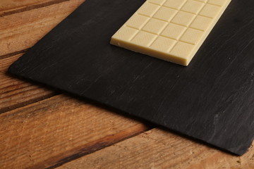 white chocolate tablet in color background