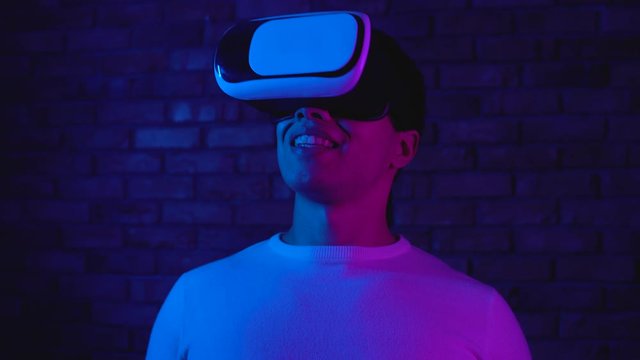 Excited man in vr headset surprised by new gaming experience in virtual reality