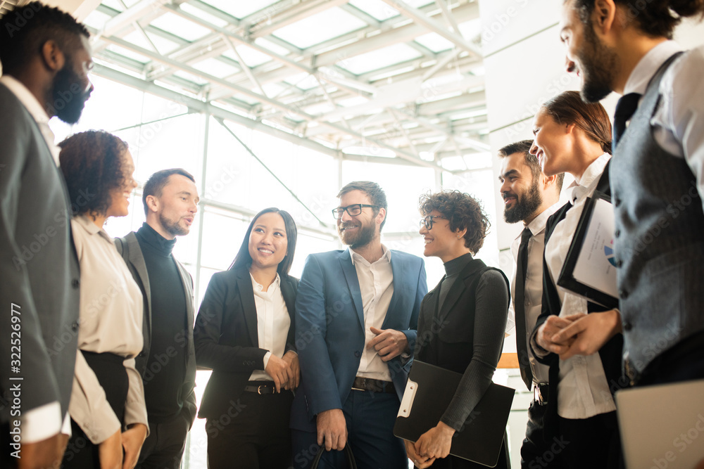 Aufkleber group of creative young multi-ethnic business colleagues standing in circle and brainstorming about 