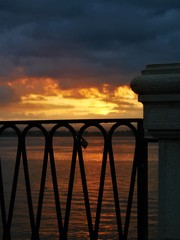 Sunset behind railing