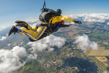 Skydive tandem free falling above the clouds