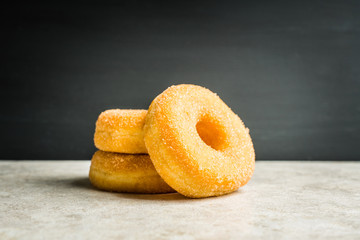 Donut with apple jam on the rustic background. Selective focus.