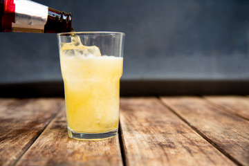 Beer in glass on wooden table.