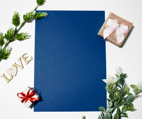blue sheet for inscription on a white background with a decor of flowers. Place for inscription