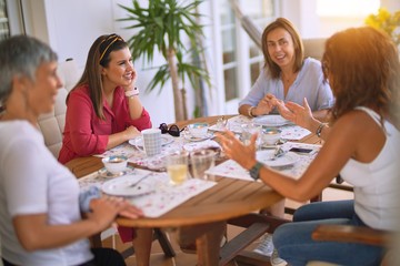 Young beautiful girl smiling happy and confident sitting dinking cup of coffee at terrace