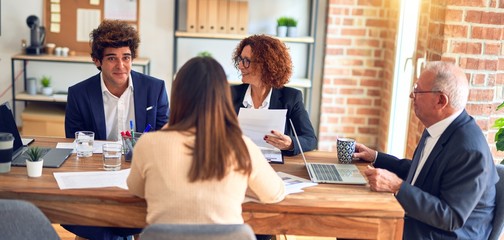 Group of business workers smiling happy and confident. Speaking with smile on face working together at the office.