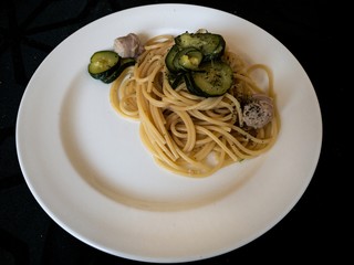 a dish of italian Gragnano doc spaghetti with sautéed courgettes and sausage