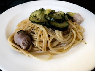 a dish of italian Gragnano doc spaghetti with sautéed courgettes and sausage