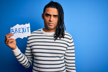 Naklejka premium Young african american afro man holding banner with brexit message over blue background with a confident expression on smart face thinking serious