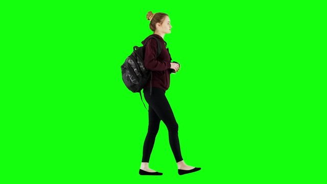 Young Girl Walking To School With a Backpack Drinking Coffee on Green Screen