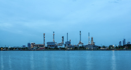 Fototapeta premium Oil refinery environmentally friendly, with sky and clouds, river