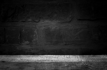 Wood table and black concrete wall background. can be used to install the product.