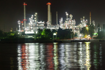 Fototapeta premium Oil refinery environmentally friendly, with sky and clouds, river