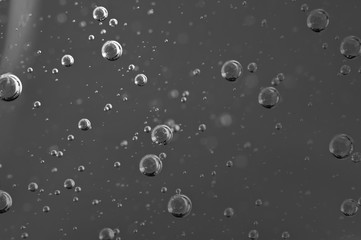Dark background. Liquid with air bubbles for projects, oil, honey, beer, juice, shampoos. Black and...