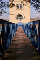 Fototapeta na wymiar Blue bridge leading to abandoned building