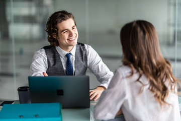 Obraz premium Beautiful business lady is looking at camera while working in office