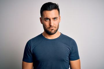 Obraz premium Young handsome man wearing casual t-shirt standing over isolated white background depressed and worry for distress, crying angry and afraid. Sad expression.