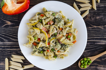 pasta with vegetables and cheese on a white plate dark wooden background home cooking concept
