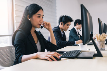 Group of call center staff talking and provide services to customers via headphones and microphone cable. Professionals with speech, memory and information recording skills.