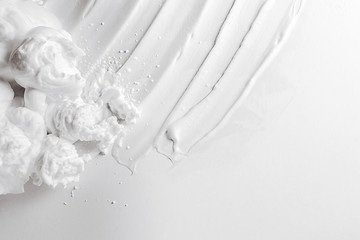White smear of cosmetic cream isolated on white background. White creamy foundation texture isolated on white background cosmetic