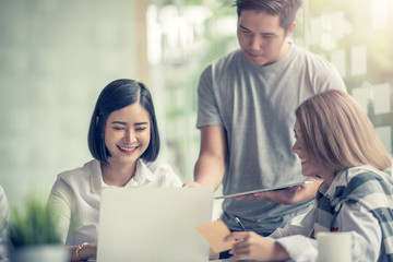 Group of young modern people in smart casual wear at meeting together to analyze and discussing business in the office.