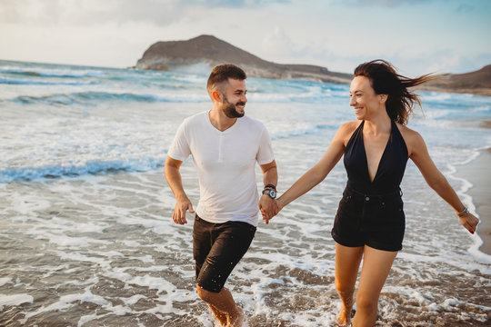 couple in love running on a beautiful beach