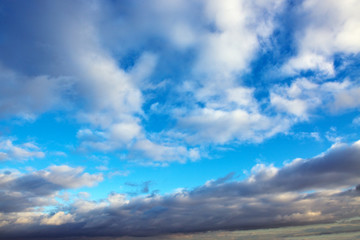 Naklejka na ściany i meble Blue sky with large clouds and sunlight. Nature background.