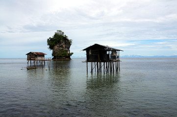 wooden huts above water in biak - Indonesia