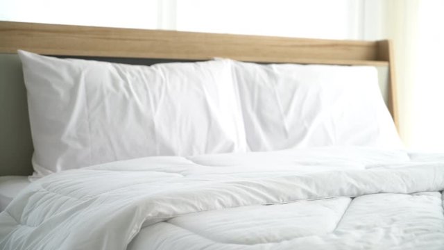 white comfortable pillow on bed decoration in bedroom