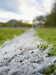 Detail of used synthetic grass for football field with milled rubber