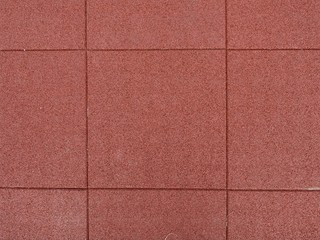 Fototapeta premium Texture of red rubber floor used for safety kids playground
