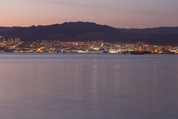 Sunset in Aqaba city, view of Eilat city in Israel. Aqaba city, Jordan