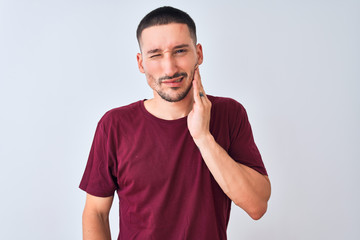 Young handsome man standing over isolated background touching mouth with hand with painful expression because of toothache or dental illness on teeth. Dentist concept.