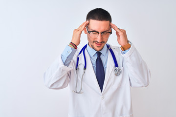 Fototapeta premium Young doctor man wearing stethoscope over isolated background with hand on headache because stress. Suffering migraine.