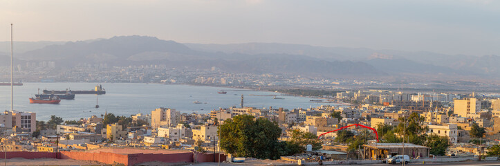Fototapeta na wymiar Sunset in Aqaba city, view of Eilat city in Israel. Aqaba city, Jordan