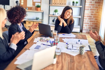 Group of business workers smiling happy and confident. Working together with smile on face applauding one of them at the office