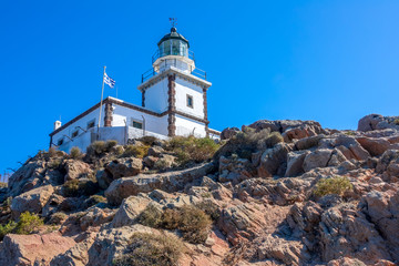 Fototapeta na wymiar Greek Lighthouse on a Sunny Cliff