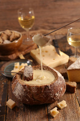 cheese fondue in bread bowl with wine