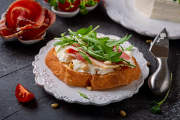Bruschetta with Italian  cheese of cow's-milk and prosciutto