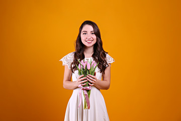 Beautiful female holding bouquet of springtime flowers for international women's day holiday.