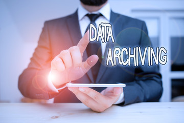 Word writing text Data Archiving. Business photo showcasing to secure and to store data for long term retention Male human wear formal clothes present presentation use hi tech smartphone