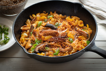 Cabbage, shiitake mushroom and pepper stewed with Asian sauce in cast iron pan