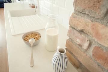 Cereals and milk on modern kitchen counter. Healthy breakfast concept