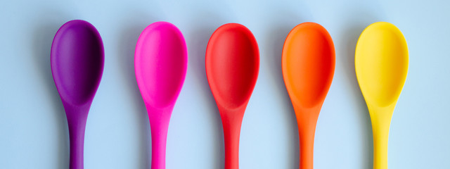 Banner for the site with multi-colored kitchen spoons.