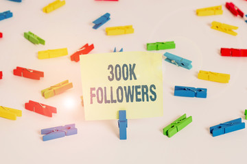 Word writing text 300K Followers. Business photo showcasing number of individuals who follows someone in Instagram Colored clothespin papers empty reminder white floor background office