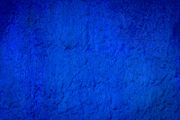Dark blue painted wall. Old colored stone wall texture.