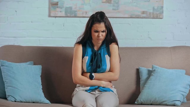 frustrated girl suffering from stomach ache