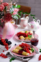 Crepes with lemon cream and raspberry jam. .selective focus.