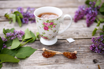 Morning beverage in the garden with flowers, fruit and tea