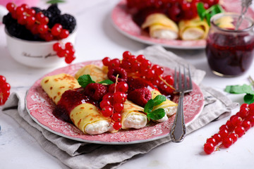 Crepes with lemon cream and raspberry jam. .selective focus.